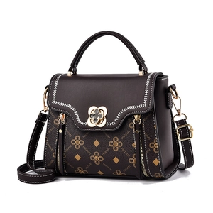 Fashionable dark brown crossbody bag with floral print and gold flower buckle detail