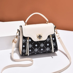 Contrast cream and black floral printed crossbody bag with metal flower clasp lock