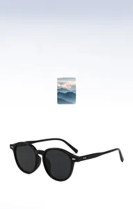 Detail view of vintage round black sunglasses with silver rivet accents and UV protection