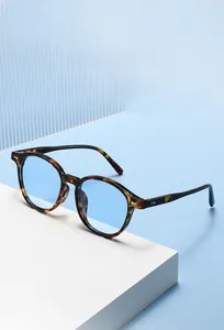 Detailed macro view of tortoiseshell frames with light blue lenses and silver rivets