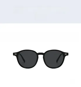 Detailed front view of black retro round frame sunglasses with silver hinge accents