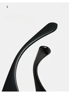 Macro view of curved glossy black temples of oversized sunglasses showing ergonomic design