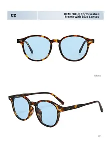 Macro detail of retro tortoise shell sunglasses frame with light blue lenses and rivets