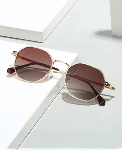 Detailed view of polygon gold metal frame sunglasses with gradient brown lenses on pedestal