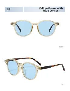 Detail view of vintage yellow frame sunglasses with blue lenses and tortoise temples