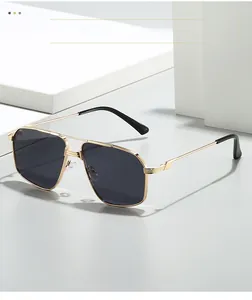 Detailed view of golden aviator sunglasses with dual-bridge metal frame and dark lenses