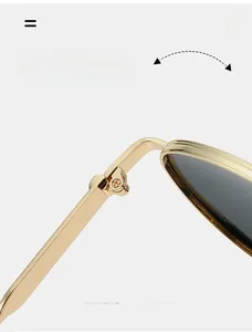Détail macro d'une charnière en métal doré champagne durable sur des lunettes de soleil