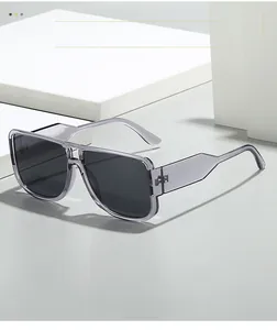 Detail of trendy oversized square sunglasses with smoke grey frame on minimalist white blocks
