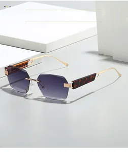 Detail of rimless square sunglasses featuring purple gradient lenses and tortoise accents