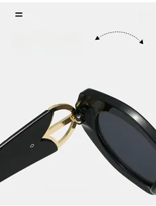 Detail of durable gold metal hinge with hollow design on black cat-eye sunglasses frame