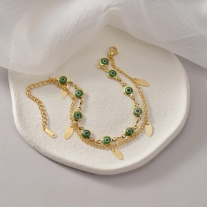 14K gold plated stainless steel layered bracelet with green evil eye beads and leaf charms