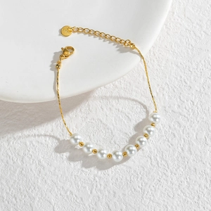 Elegant gold stainless steel bracelet with white pearls and adjustable lobster clasp