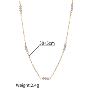 Detail of a 38+5cm stainless steel gold chain necklace with light grey beaded accents