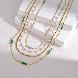 Multilayered stainless steel necklace set with pearls and green beads for a layered look
