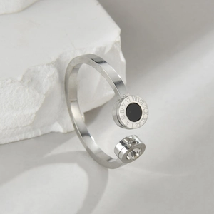 Macro detail of silver ring with Roman numerals engraving and clear zircon stone inlay