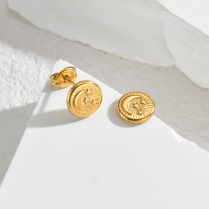 Golden stainless steel celestial earrings with embossed star and moon on white stone