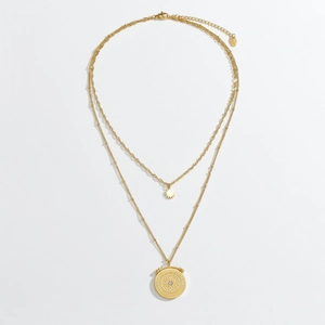 Detail of double-layer gold 18K necklace featuring sunburst and relief medal pendants
