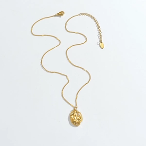 Detail of gold stainless steel necklace with organic lava pendant and adjustable chain