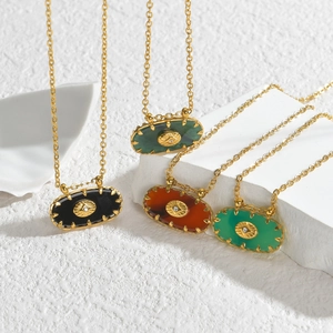 Oval sunburst pendant necklaces in four colors on minimalist geometric pedestals