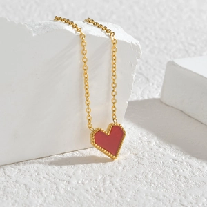 Minimalist gold O-chain necklace with a red enamel heart pendant and beaded edges