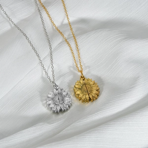 Vintage stainless steel sunflower locket necklaces in gold and silver on white silk