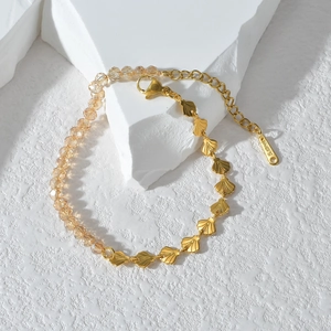 Detail of gold fan shell bracelet with crystal beads and stainless steel clasp