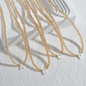 Collier de perles champagne avec pendentifs lettres A-D au style minimaliste