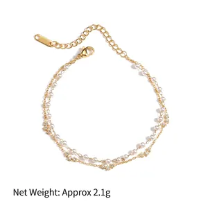 Double-layered gold chain bracelet with white pearls and sparkling star pendant