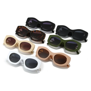 Set of seven chunky cat-eye sunglasses in various colors on white background