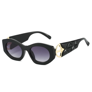Fashionable cat eye sunglasses with gold metal accents and geometric textured temples