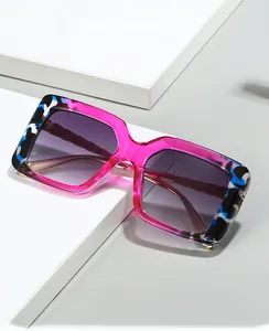 Detail of pink transparent square sunglasses with artistic tortoise pattern on the frame corner