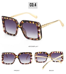 Detail of tortoiseshell square sunglasses with purple gradient lenses and bamboo gold temples