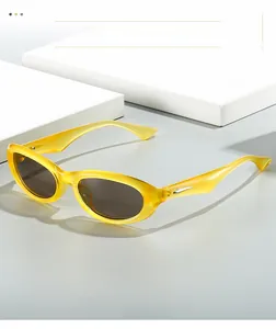 Detail of yellow translucent frame with metal accent on Y2K futuristic sunglasses