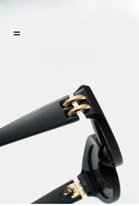 Macro detail of high-quality golden metal hinge on durable black cat-eye sunglasses