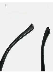 Detailed macro view of curved mirror legs on sleek black cat-eye sunglasses frames