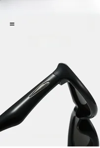 Detail view of glossy black glasses temple featuring silver metal teardrop inlay and hinge