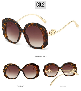 Detailed views of tortoise shell oval sunglasses with double-heart metal temple accents