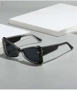 Detail of modern cat-eye sunglasses with grey translucent frames and dark lenses