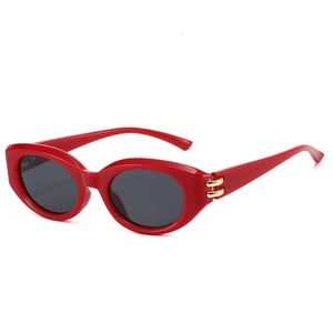Modern red cat eye sunglasses for women with gold metal ring detail on the side temples