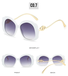 Three views of sunglasses with white wavy frames, purple lenses, and golden heart temples