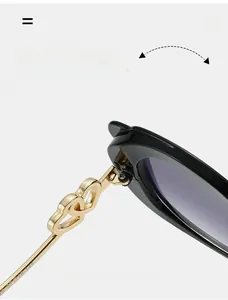 Macro view of durable metal hinges and gold interlaced heart decor on sunglasses