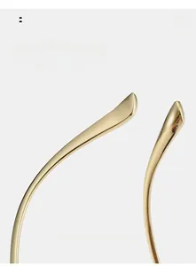 Detail of curved golden metal temples for sunglasses with comfortable ergonomic design