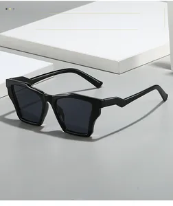 Detail of black geometric square sunglasses with dark lenses on minimalist background
