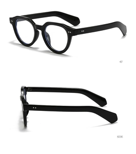 Detail of vintage round black sunglasses featuring stylish metal rivets and sleek finish