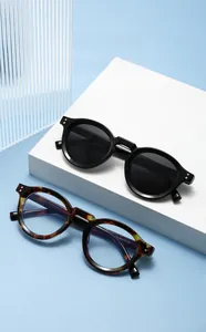 Macro shot of vintage round sunglasses in black and tortoiseshell with silver rivets