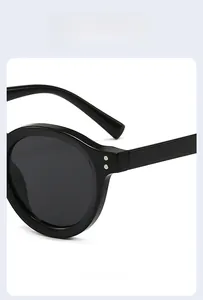 Close-up of vintage black round sunglasses with silver rivets and metal hinges
