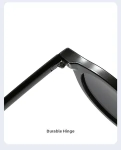 Close-up of the durable metal hinge and sleek black frame of retro round sunglasses