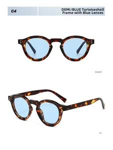 Detail view of retro tortoiseshell round sunglasses with light blue lenses and metal rivets
