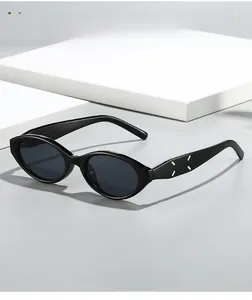 Detail view of oval cat-eye sunglasses with signature four-stitch design on the temple