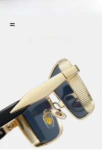 Detail of gold metal frame with textured vertical stripes and black acetate temple arms